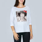 A woman wearing SUZI ROHER's The Bailey, a white boxy 3/4 sleeve tee with a black and white portrait graphic and “VANITY FAIR” and “The making of a legend” text, channels classic Coco Chanel style.
