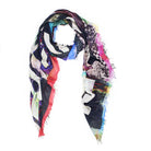 The SUZI ROHER "Kim Make Art Not War" is a lightweight modal silk scarf with an abstract black, white, blue, pink, red, and green pattern, frayed edges, and Italian craftsmanship. It is shown loosely draped on a white background.