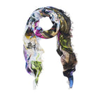 The SUZI ROHER "Nothing Like A Vespa" is a lightweight, rectangular Modal Silk scarf with frayed edges, showcasing a colorful abstract pattern in blue, green, purple, and brown on a white background. Made in Italy.