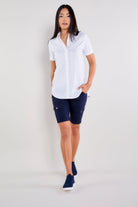 The Best Travel Top. Woman Showing the Front Profile of a Helia Top in White.